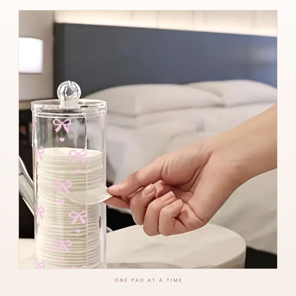 Taking a single cotton pad from the dispenser